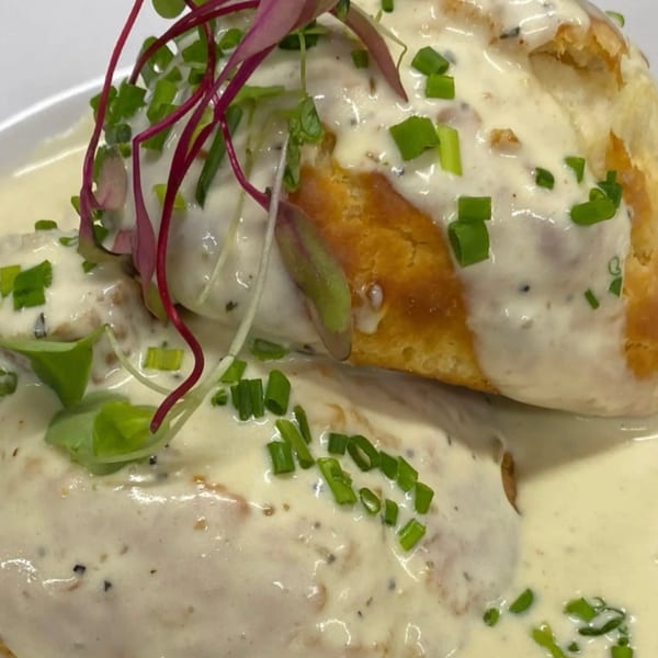 Biscuits and gravy from Toast It IZ, topped with chives and microgreens.